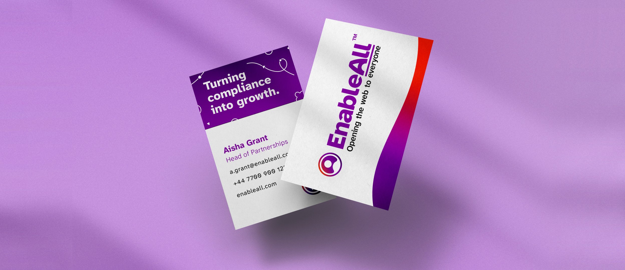EnableAll business cards, a purple back and a white front with the wordmark, on lilac.