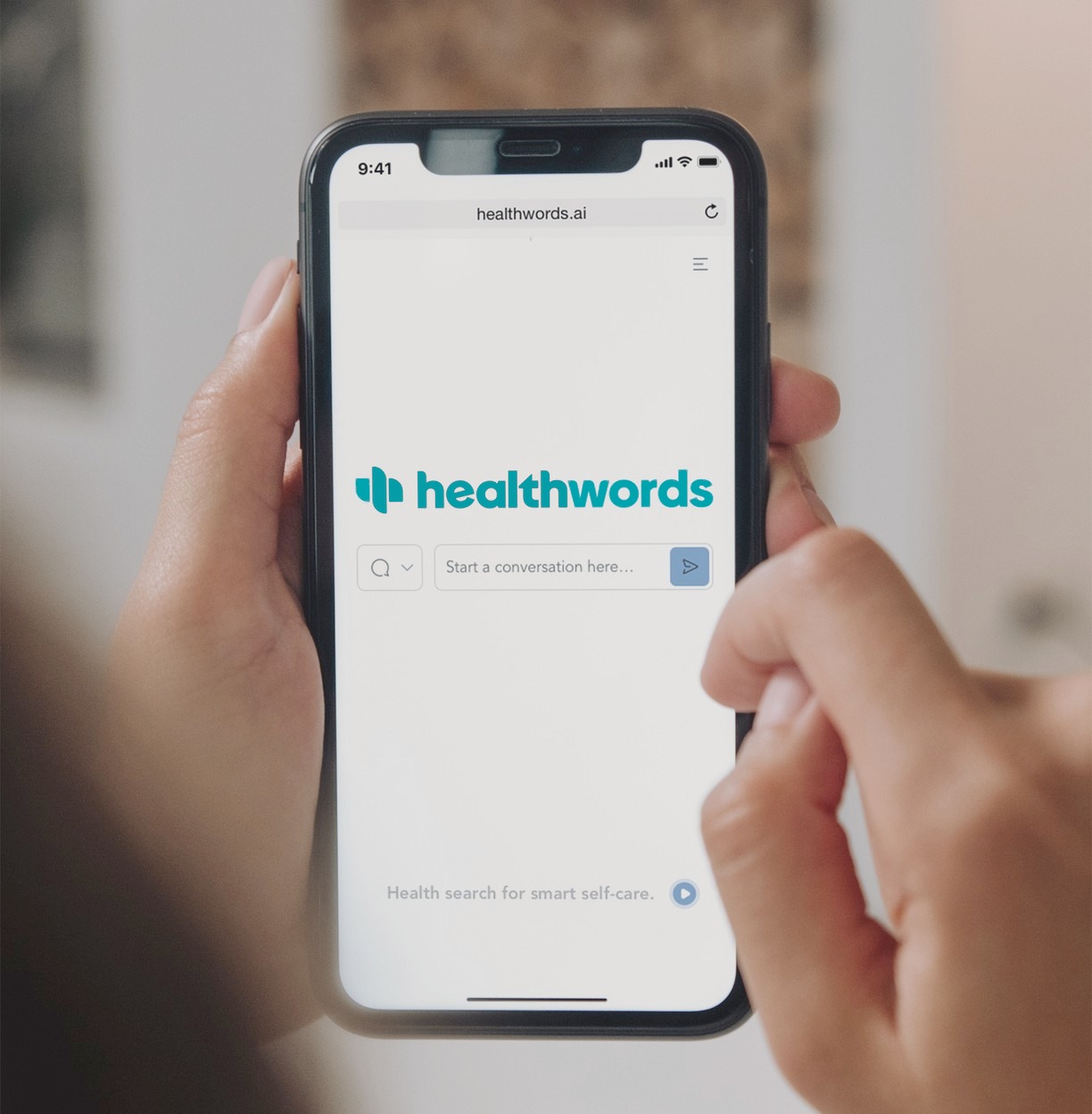 A phone showing the Healthwords home screen, indoors.