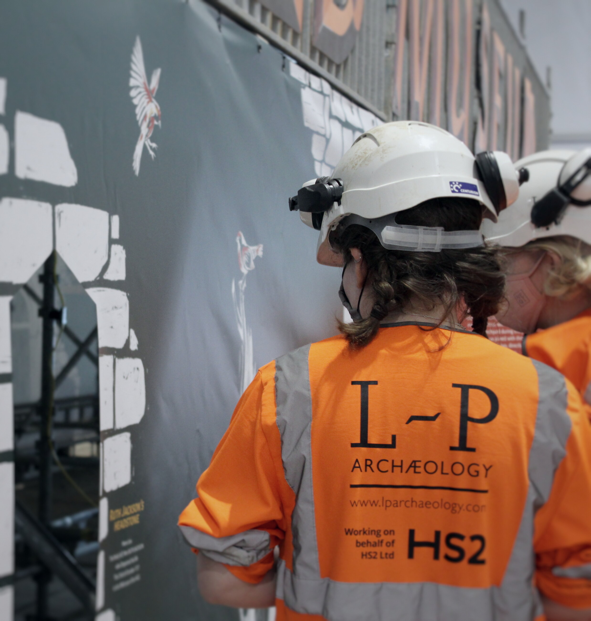 An archaeologist in an L-P and HS2 hi-vis jacket.